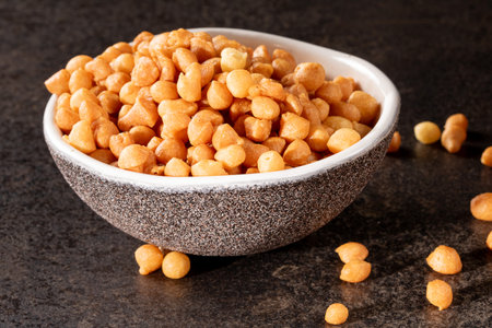 A bowl filled with a hearty and delicious soup, accompanied by a snack product, set against a dark background, creating an appetizing and visually appealing composition. Perfect for culinary concepts.の写真素材