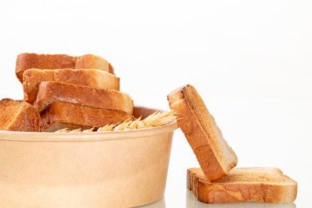 A close-up of a delicious crispy white bread toast placed on elegant white table setting, perfect for breakfast or brunch, adding warmth and elegance to the meal.の写真素材
