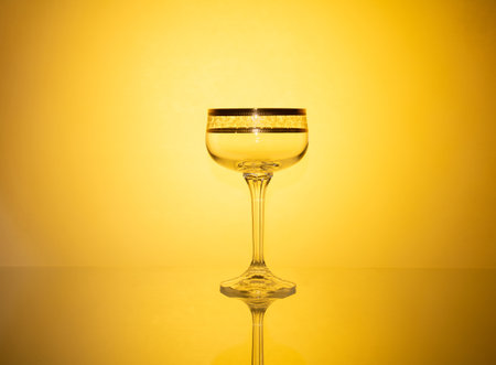 An artistic arrangement of glassware capturing the radiance of dynamic colored lighting effects, producing a captivating and mesmerizing visual display with an enchanting glow.の写真素材