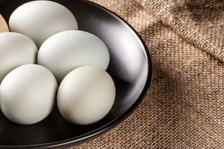 Explore the visual appeal of environmentally friendly chicken eggs laid out on a beautiful vintage...