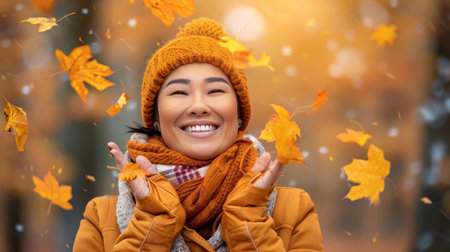 Joyful asian woman playfully tosses colorful autumn leaves in a lively city park environmentの素材