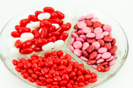 Assorted Valentines Day candies of cinnamon hearts, Valentine smarties and red and white jelly beansの写真素材