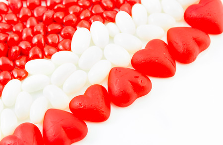 Assorted Valentines Day candies of Jube hearts,cinnamon hearts and  white jelly beansの写真素材