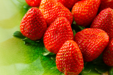 Fresh organic strawberries on green backgroundの写真素材