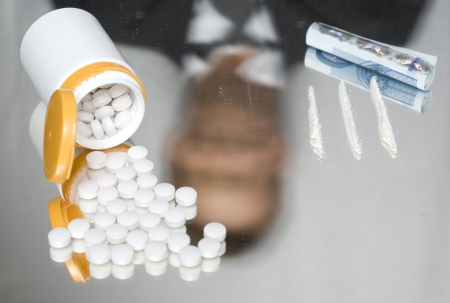 Drugs on a mirror. Shaky, out of focus reflection of a businessman.の写真素材
