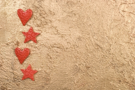 Red hearts and stars on a golden surface. の写真素材