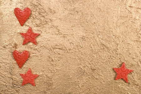 Red hearts and stars on a golden surface.の写真素材