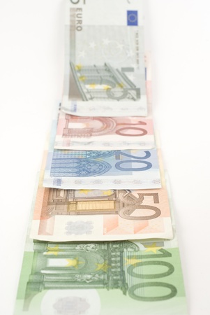 Euro banknotes disappearing in the horizon. Isolated on white.の写真素材