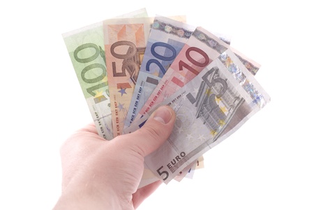 Euro banknotes in a hand. Isolated on white.の写真素材