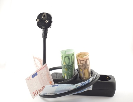 Electricity cable, plug and socket covered with banknotes.の写真素材