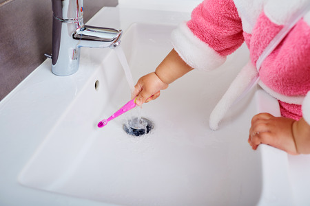 Child hand with toothbrushの写真素材