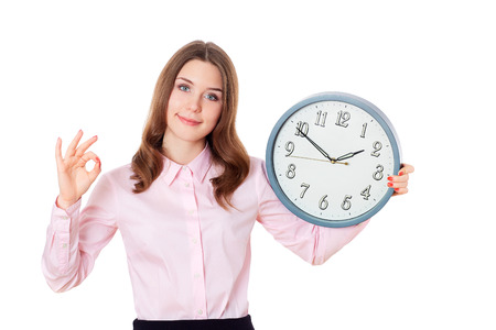 Blond girl showing ok okay success hand sign gesture isolated on white.Businesswoman holding clock.Wall Clock.の写真素材