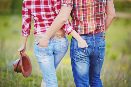 Young couple hugging Rear view. Cowboy style.の写真素材