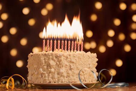Cake shot on a bokeh background with candles.の写真素材