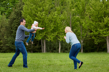 Family playing in the park.の写真素材