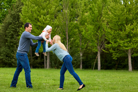 Parents playing exciting  with child In the park.Happy family.の写真素材