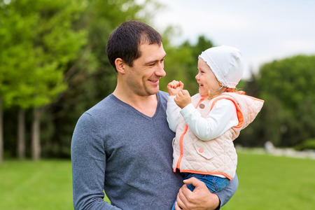 Daughter with her father in the park.の写真素材