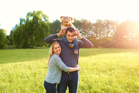 Happy family having fun outdoors and smiling. Mom,dad and daughterの写真素材