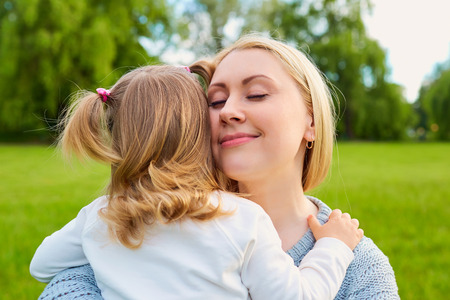 Portrait of young mother with her adorable little girl. Happy mom with child.の写真素材