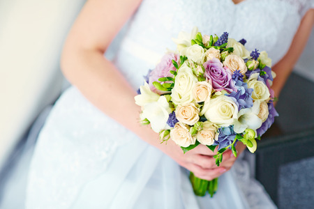 Beautiful wedding bouquet in hands of the brideの写真素材