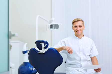 Dentist with image in the hands of workplace hospital his office.の写真素材