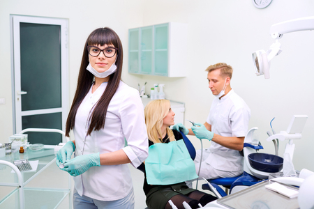 Dentist woman in glasses  on background equipmentの写真素材