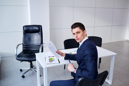 Businessman with contract paper in hand at the table office.の写真素材