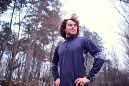 Young sporty man on nature in the park  a background of trees.の写真素材