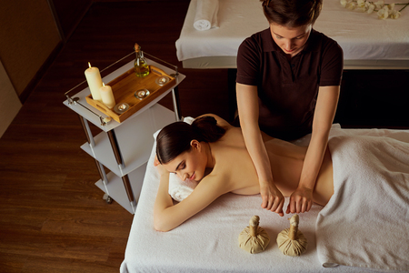 Massage of young woman lying in spa salon.の写真素材