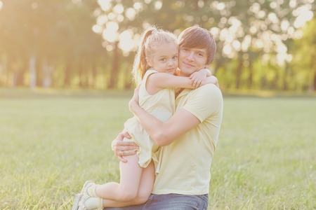 Father and daughter hugging in the park in summer. Father Day.