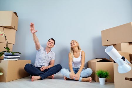 Concept of housewarming relocation. Couple in a new house apartment.の写真素材