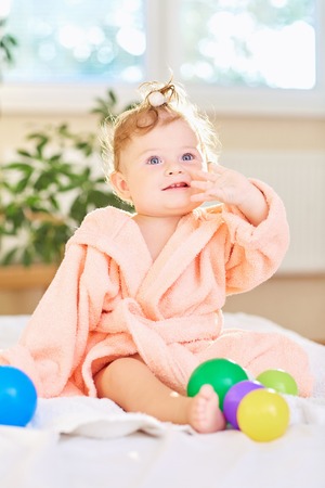 Baby cute in the bathrobe after the bath.の写真素材