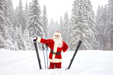 Santa Claus skiing in the mountains on snow in winter in Christmas. Christmas in the mountains.の写真素材