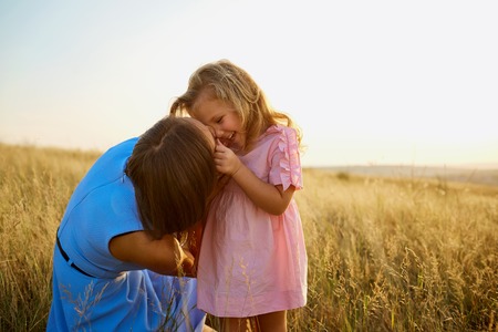 Mother and daughter in nature at sunset. Mothers Day.の写真素材