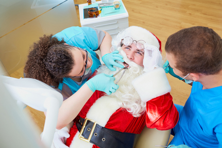 Santa Claus at a reception at the dentist's office in the Christmas, New Year.の写真素材
