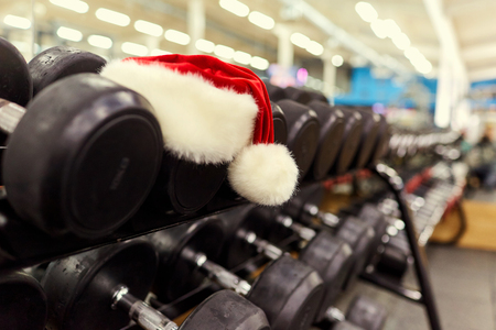 Santa's hat in the gym. Concept of sports on Christmas and New Year.の写真素材