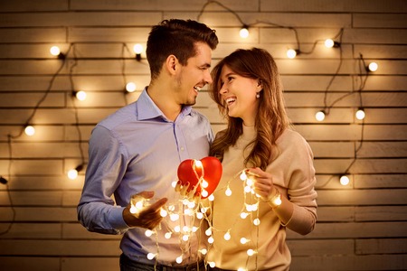St. Valentines Day. A loving couple with a heart in garland light.の写真素材