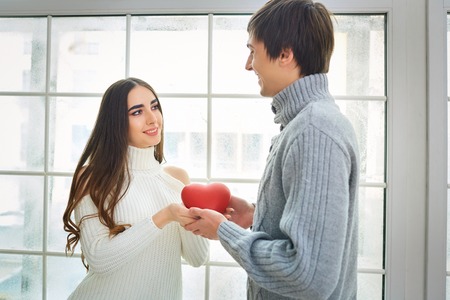Young couple with a heart in love couple. The concept of St. Valentines Day.の写真素材
