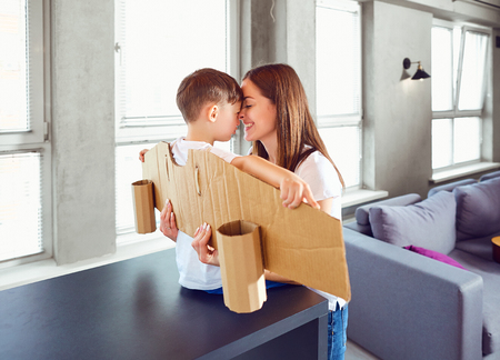 Mother and son play in superheroes indoors.の写真素材