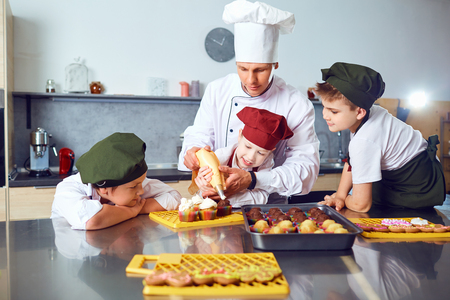 Children learn to cook in the classroom in the kitchen.の写真素材