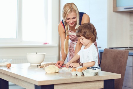 Mother and son bake cakes in the kitchen.の写真素材