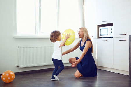 Mom and child are playing in the room. Parenting.の写真素材