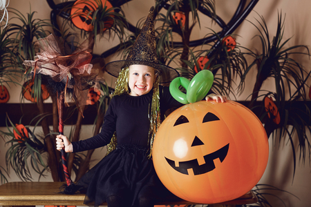 Funny little girl in a Halloween costume.の写真素材