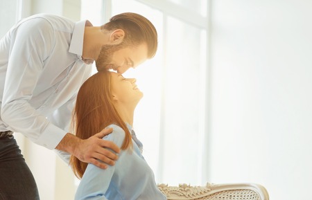 Romantic kiss couple against the window. St. Valentines Day.の写真素材