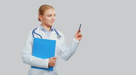 Woman doctor therapist with stethoscope smiling on the background.の写真素材