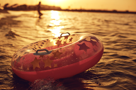 An inflatable circle for swimming in the sea on a beautiful sunset.