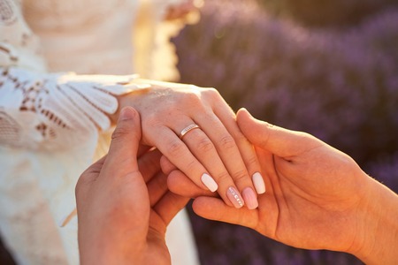Marriage proposal in a field of lavender in the evening at sunset.の写真素材