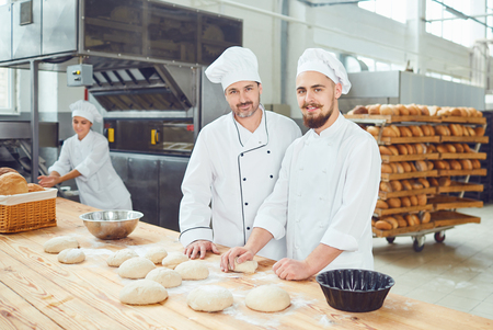 Men bakers in the workplace in the bakery.