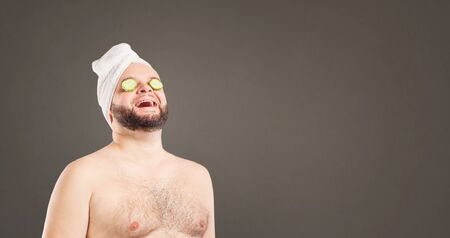 A funny man in a face mask in a beauty salon.の写真素材