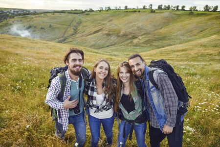 Friends hikers smiling at camping trip in nature